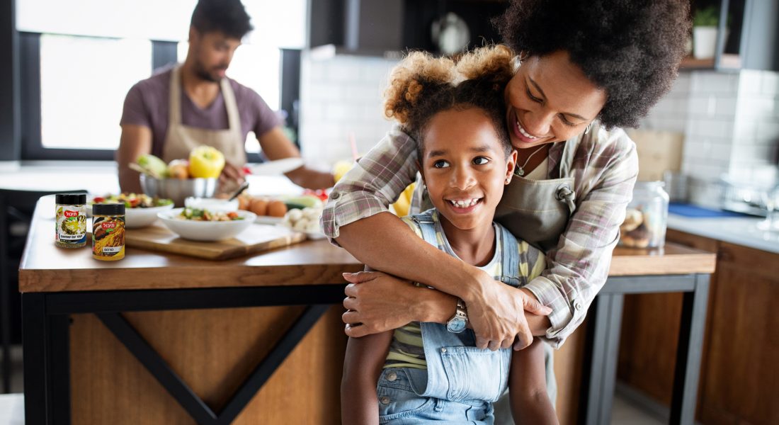Happy african american family preparing healthy food in kitchen together